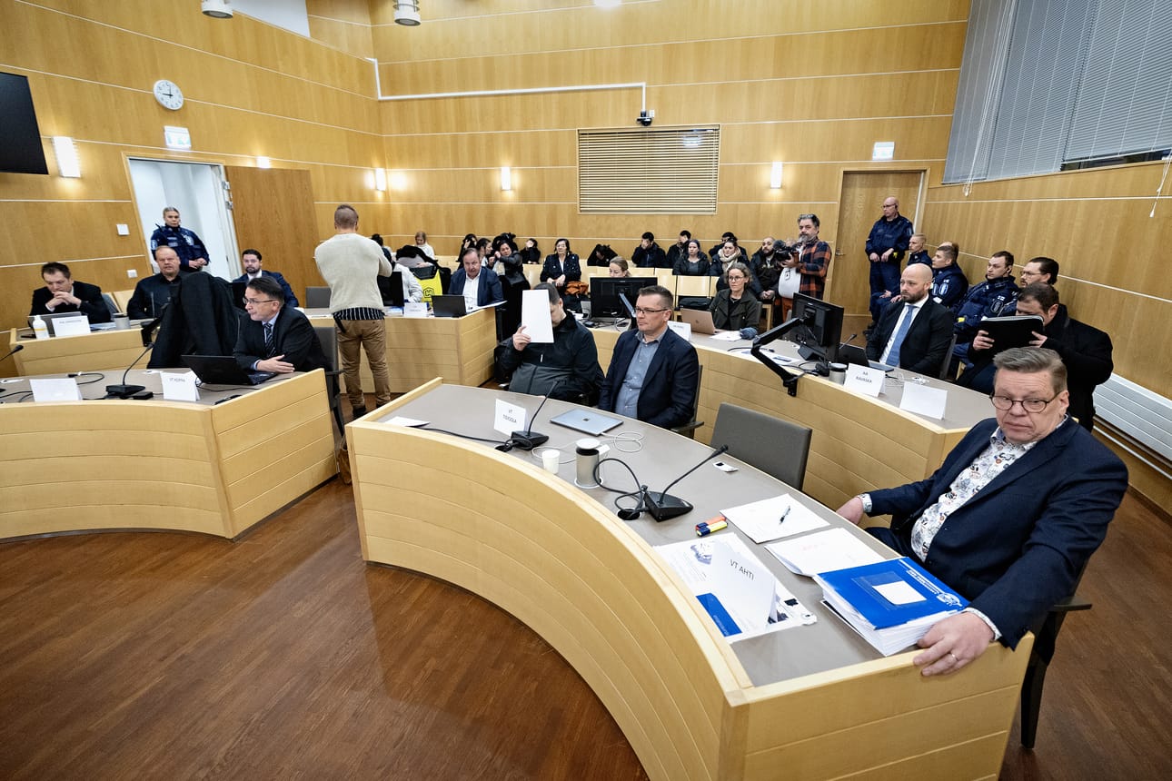 Syytettyjä edustavat Kari Eriksson ja Tuukka Tieksola ovat nokitelleet koko oikeudenkäynnin ajan. Tieksola eturivissä kasvonsa peittävän miehen vieressä, Eriksson vasemmalla olevan toisen penkkirivin päässä.