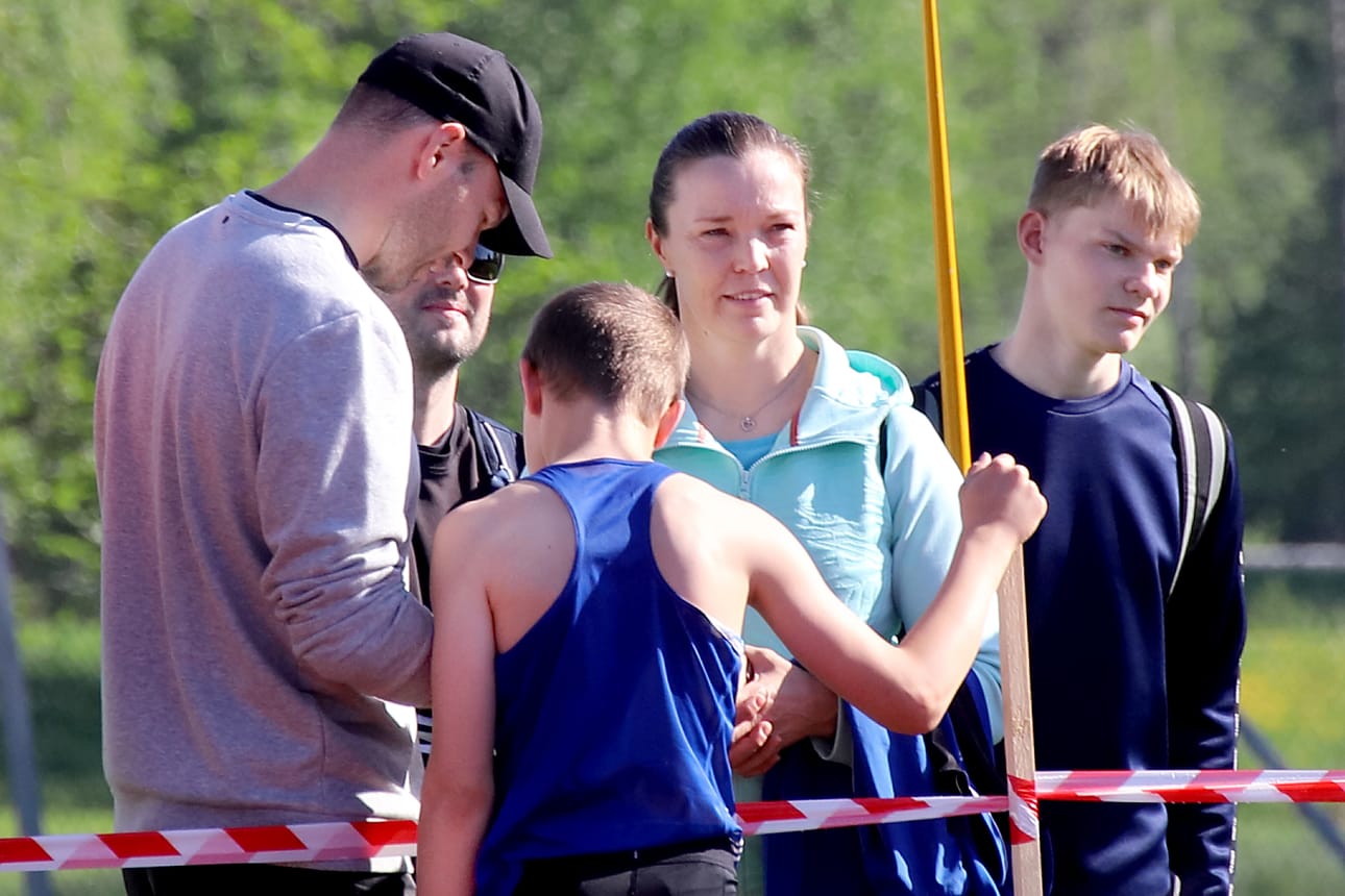 Tero Pitkämäki ohjeistaa poikaansa Jimiä seuraavaan heittoon. Äiti Niina Kelo vieressä.