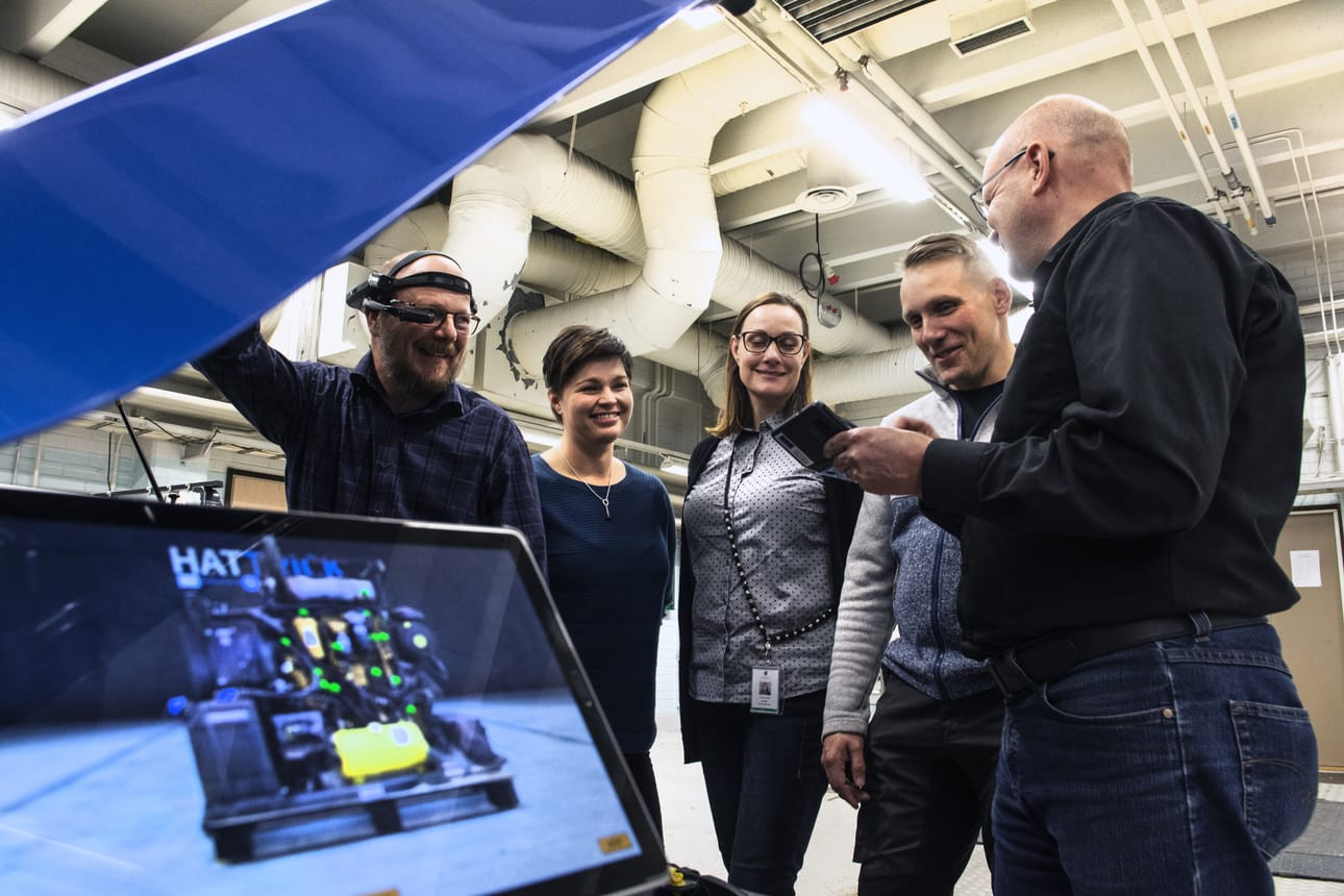 Juha Merran (vas) näkökentässä olevaan näyttöön tulee moottorin kytkentäkaavio, jonka huoltoon ohjeet tulevat videoneuteotteluna vaikka toiselta mantereelta.Tanja Koukkula, Viivi Sirkeinen ja Jyrki Kurtti näkevät ohjeet Ari Kanasen kännykältä.