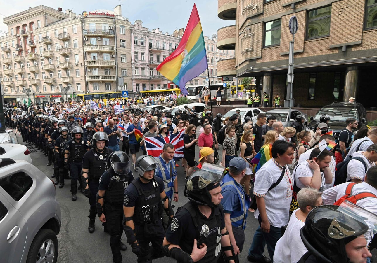 Pride-kulkueen osallistujat kantoivat lippuja poliisien saattelemina Kiovassa vuonna 2019. LEHTIKUVA / AFP