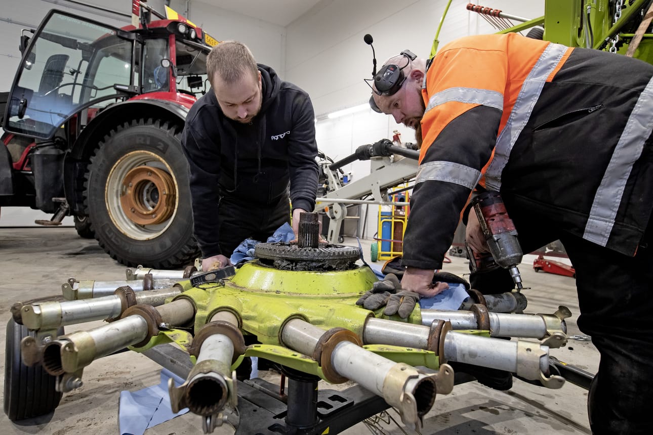Janne Luoma ja Juhamatti Turpeenoja tarkastelevat korjausta kaipaavaa karhotinta. Hallissa mahtuu korjaamaan myös asiakkaiden koneita.