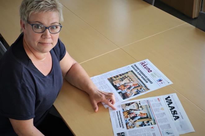Pia Ojanen vertailee Ikkunassa tammikuussa 2021 julkaistua juttua Liisa Kosken herkkukaupasta uuden Vaasa-lehden koeversioon, jossa sama juttu on taitettu lehden paraatiaukeamalle. Lopputulos on ilmava ja visuaalisesti näyttävämpi. Kuva: Anne Laurila