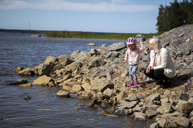 Sanna Kallio pienen Eevi tyttönsä kanssa nauttii asuinalueensa merellisestä maisemasta. Hän pitää aluetta turvallisena ja lapsiperheille mainiona. KUVAT: SAMI PELTONIEMI