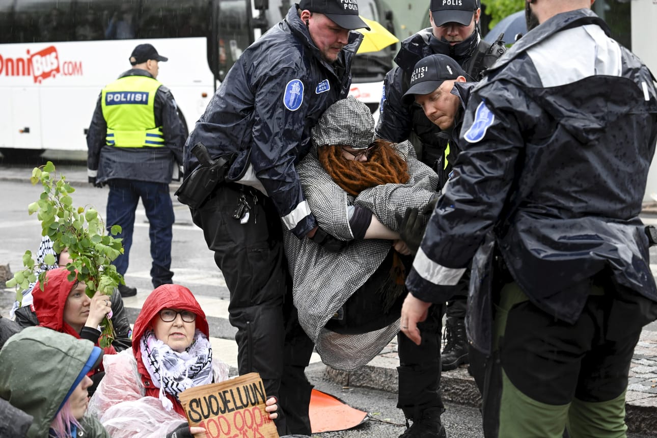 Poliisi siirsi maanantaina Elokapinan Kulovalkea-mielenosoituksen mielenosoittajaa pois ajoradalta Mannerheimintien ja Helsinginkadun risteyksessä. LEHTIKUVA / Markku Ulander