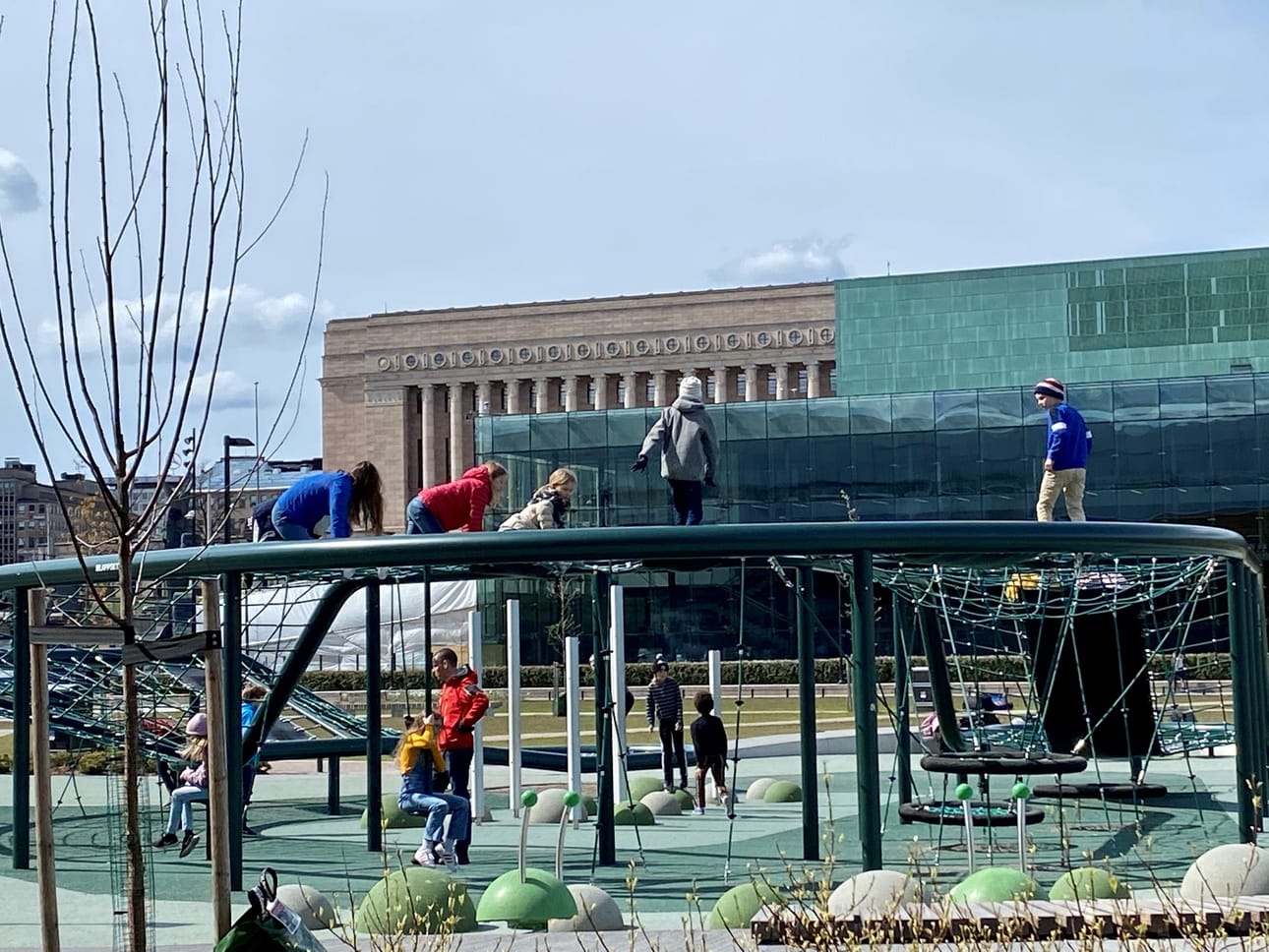 Children play outside in the centre of Helsinki on Thursday. Eduskunta or the house of Finnish parliament is seen in the background.