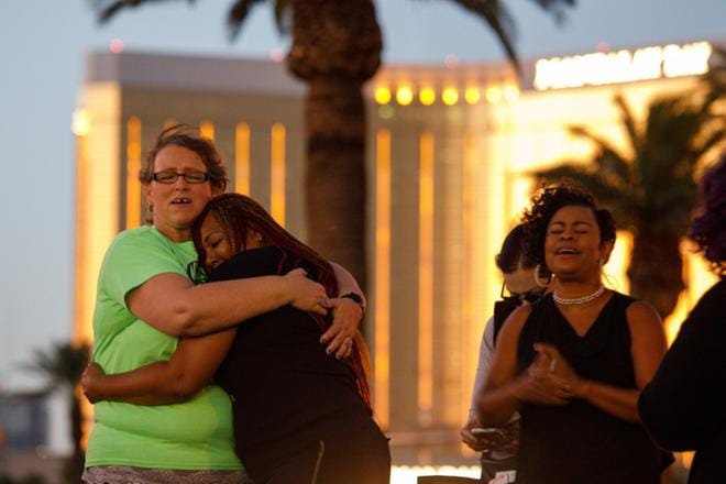 Lähikirkon seurakuntalaiset rukoilevat joukkoampumisen uhrien puolesta Mandalay Bay -hotellin ulkopuolella Las Vegasissa keskiviikkona. Stephen Paddock ampui hotellin 34. kerroksen ikkunasta väkijoukkoon varhain maanantaina Suomen aikaa. KUVA: EPA/EUGENE GARCIA