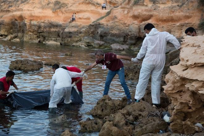 Arkistokuvassa Libyan Punaisen puolikuun työntekijät nostavat kesäkuussa 2017 maihin merellä kuolleita siirtolaisia. KUVA: EPA