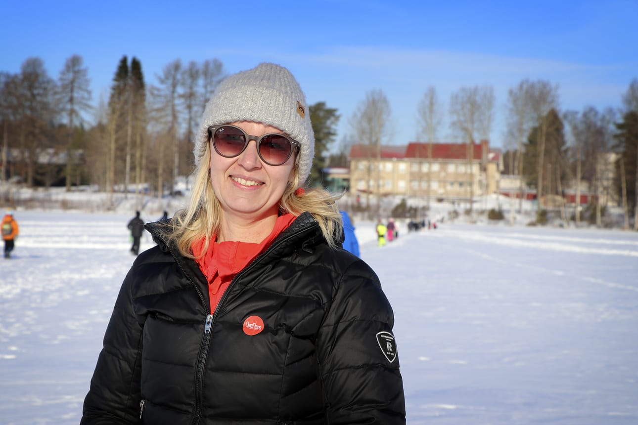 Hoiskon oppilaiden kalasaaliista kertoi opettaja Anne Kantola. Hänen takanaan näkyy koulurakennus, joka sijaitsee pilkkipäivän kannalta otollisesti Alajärven Hoiskonlahden rannalla.