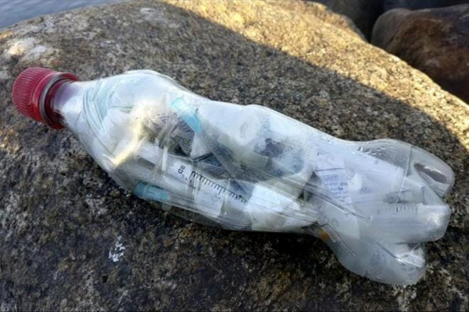 Injektioruiskuja täynnä ollut muovipullo löytyi Lappajärven rannalla syyskuun lopulla. Lukijan kuva: Timo Malminiemi