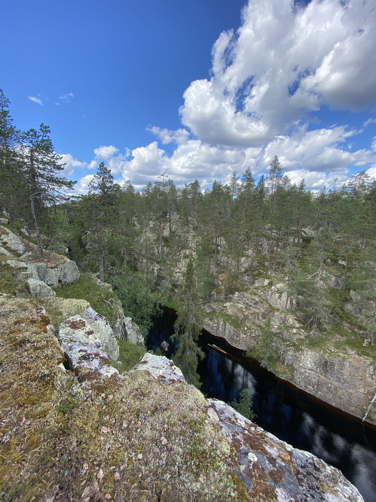 Kalliohalsin rotkojärven vesi kiiluu kaukana alhaalla tummana ja mustana.