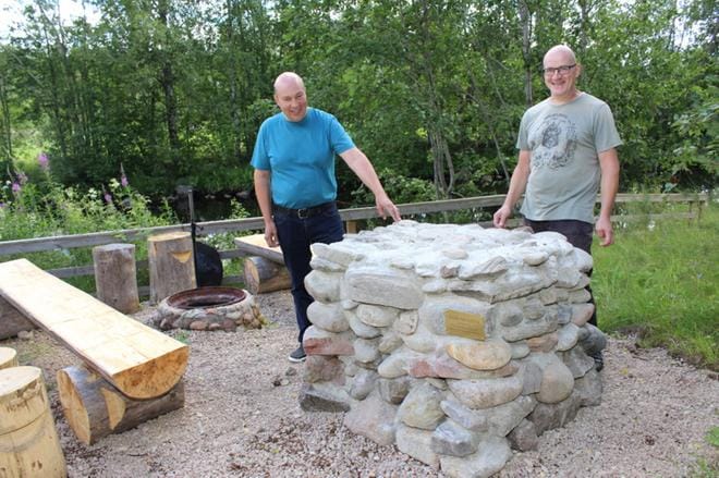 Suojokelaiset Esa Lehtimäki ja Juha Haanpää kivimonumentin äärellä Suojoen uimarannalla. KUVA: MINNA ZILLIACUS