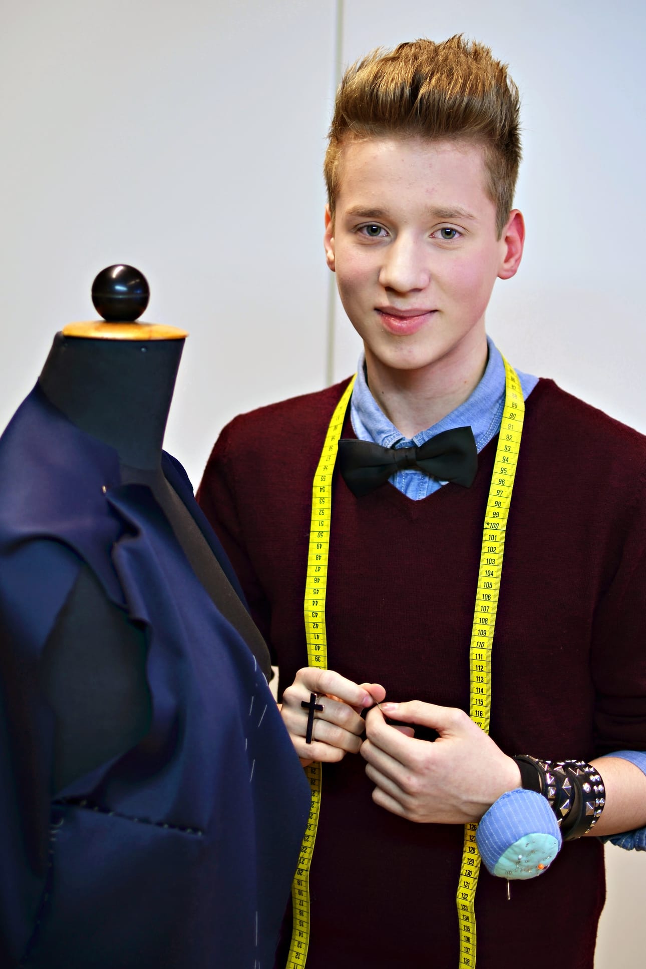 Janne Naakka pukeutuu myös kouluun. Jannella on koulupoika-tyylinen asu. Persoonallista vivahdetta asuun tuovat rusetti ja ristisormus.