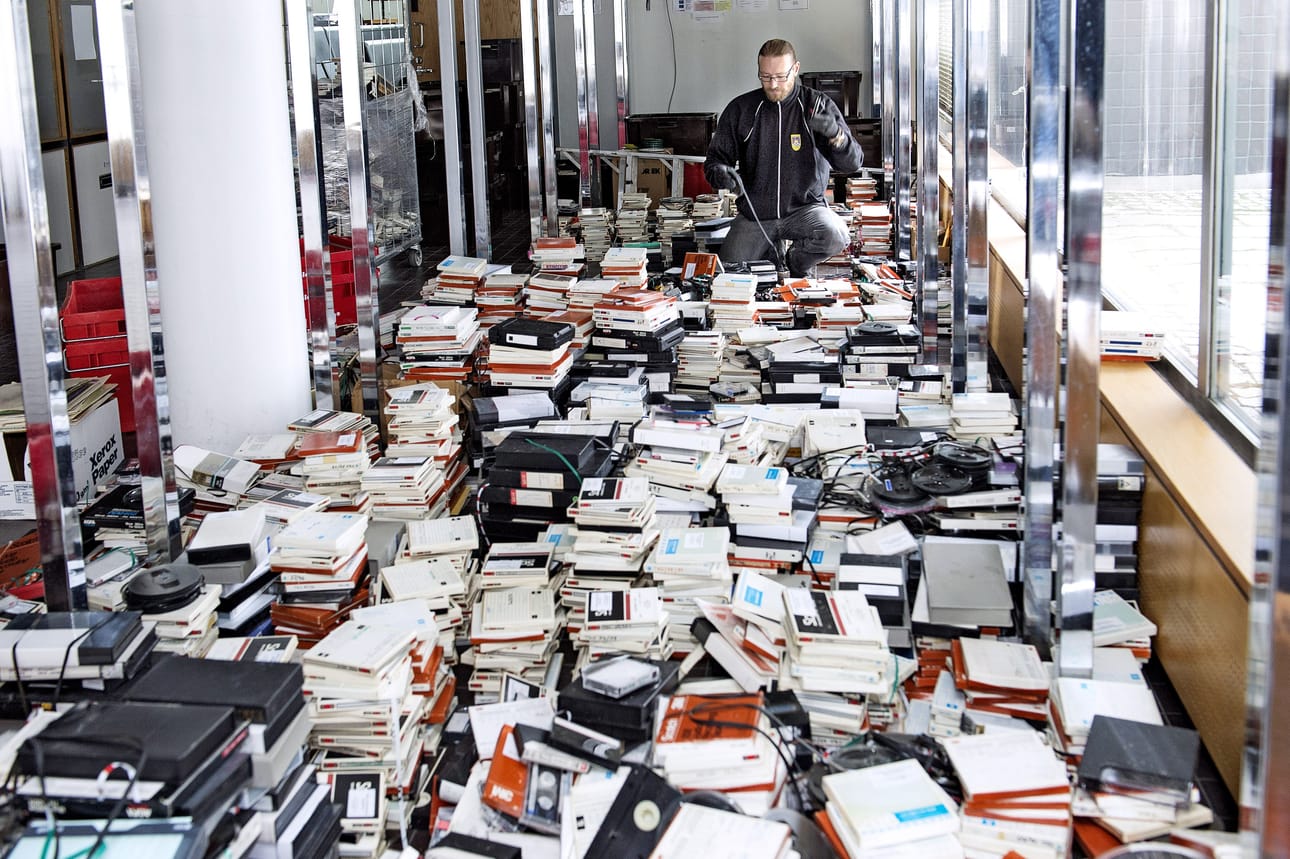 Arkistosihteeri Aki Luotonen tutki tiistaina roskalavalle räntäsateeseen joutuneen TKU-kokoelman tuhojen laajuutta.