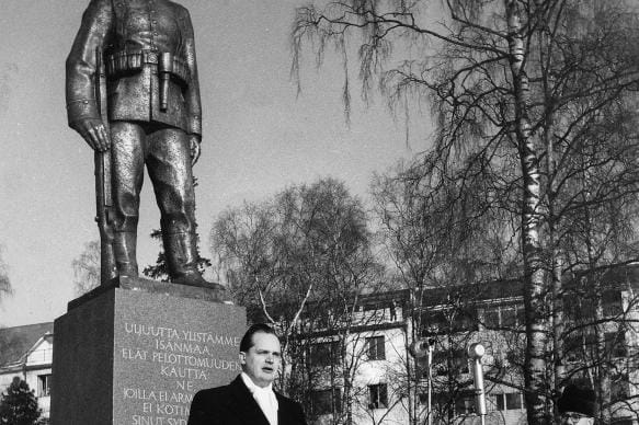 Tohtori Kalle Österlund puhuu Jääkäripatsaan paljastustilaisuudessa Vaasan Hovioikeudenpuistossa 25.2.1958. Kuvitusta kirjaan Isänmaan puolesta.