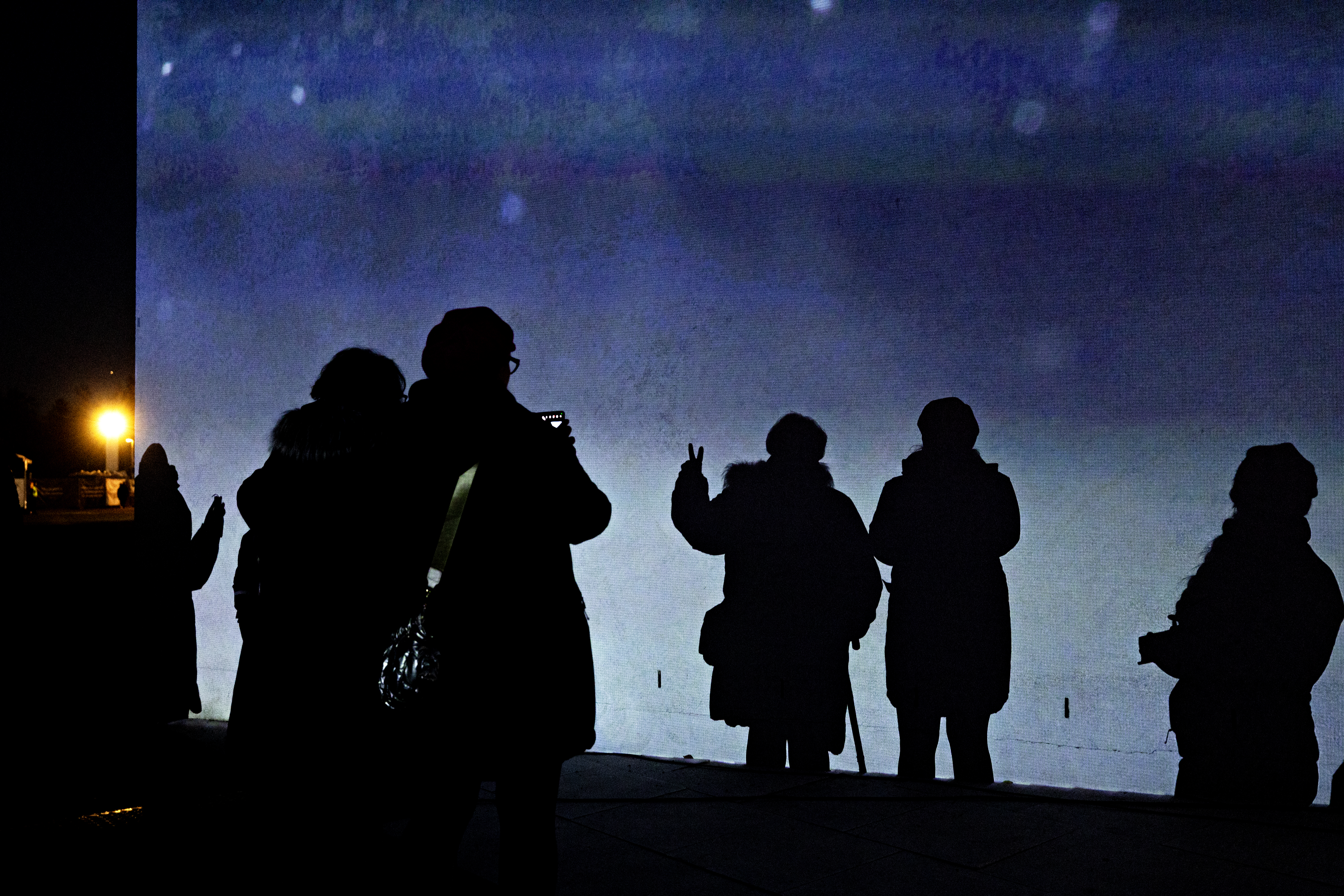 Valot ja varjot vetivät väkeä Apila-kirjaston seinustalle.