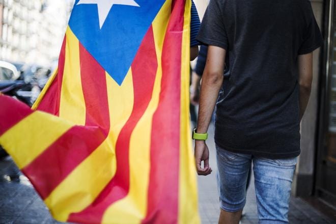 Lähestyvä äänestys näkyi selvästi Barcelonan katukuvassa jo perjantaina. Tuhannet katalaanit olivat pukeutuneet Katalonian lippuihin. Kadulla kävelevä mies sai kitkerää palautetta vastaan tulleelta naiselta, joka kehotti häntä painumaan kotiinsa. Kuva: Silja Viitala