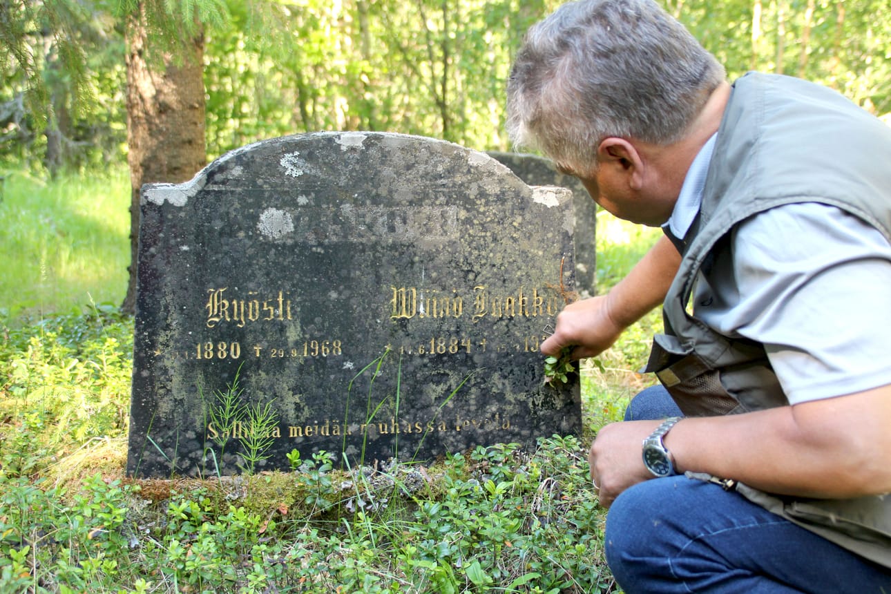Raimo Niinimaa Väinölän ensimmäisen vainajan haudalla. Ehkä alkuhämmingin vuoksi Väinö Vaskurin kiveen on kirjoitettu ”Sallikaa meidän rauhassa levätä”.