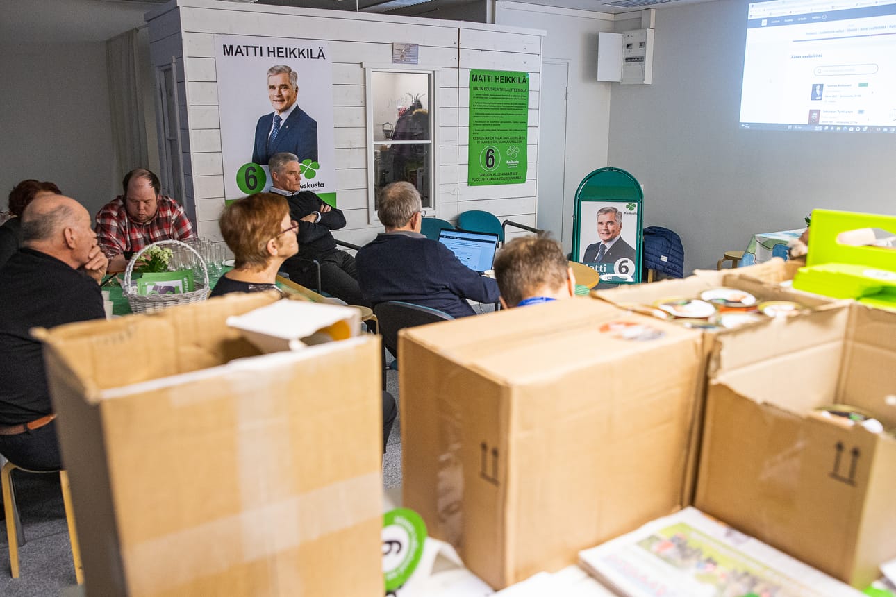 Keskustan vaalivalvojaiset Kuusamossa. Kansanedustajaehdokas Matti Heikkilä kuvassa keskellä, julisteen edessä.