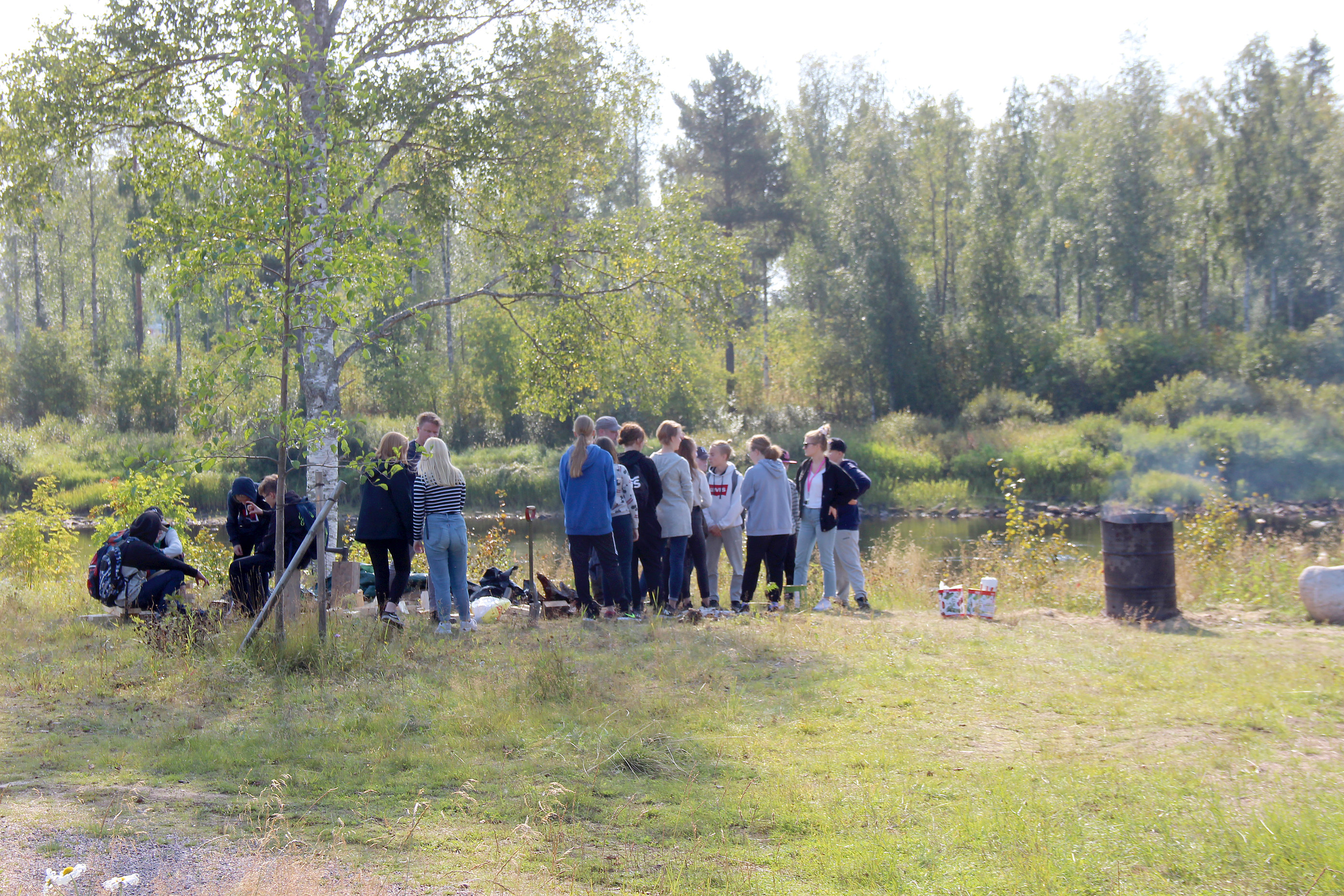 Terva tuoksui Iijoen rannassa Pudasjärvi-päivänä. Tehtaan toimintaa uteliaille esittelivät Hirsikampuksen Jopo-luokan opettaja Ville Eroma ja ohjaaja Janne Laakkonen.