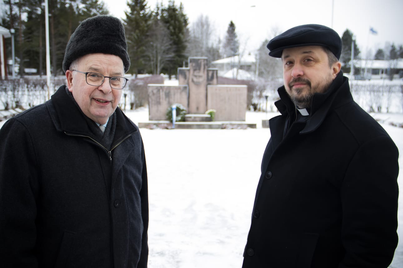 Erkki Tölli ja kirkkoherra Teemu Isokääntä hiljentyivät sankarihaudalla. Taustalla kajahtelivat talvisodan muistokellot.