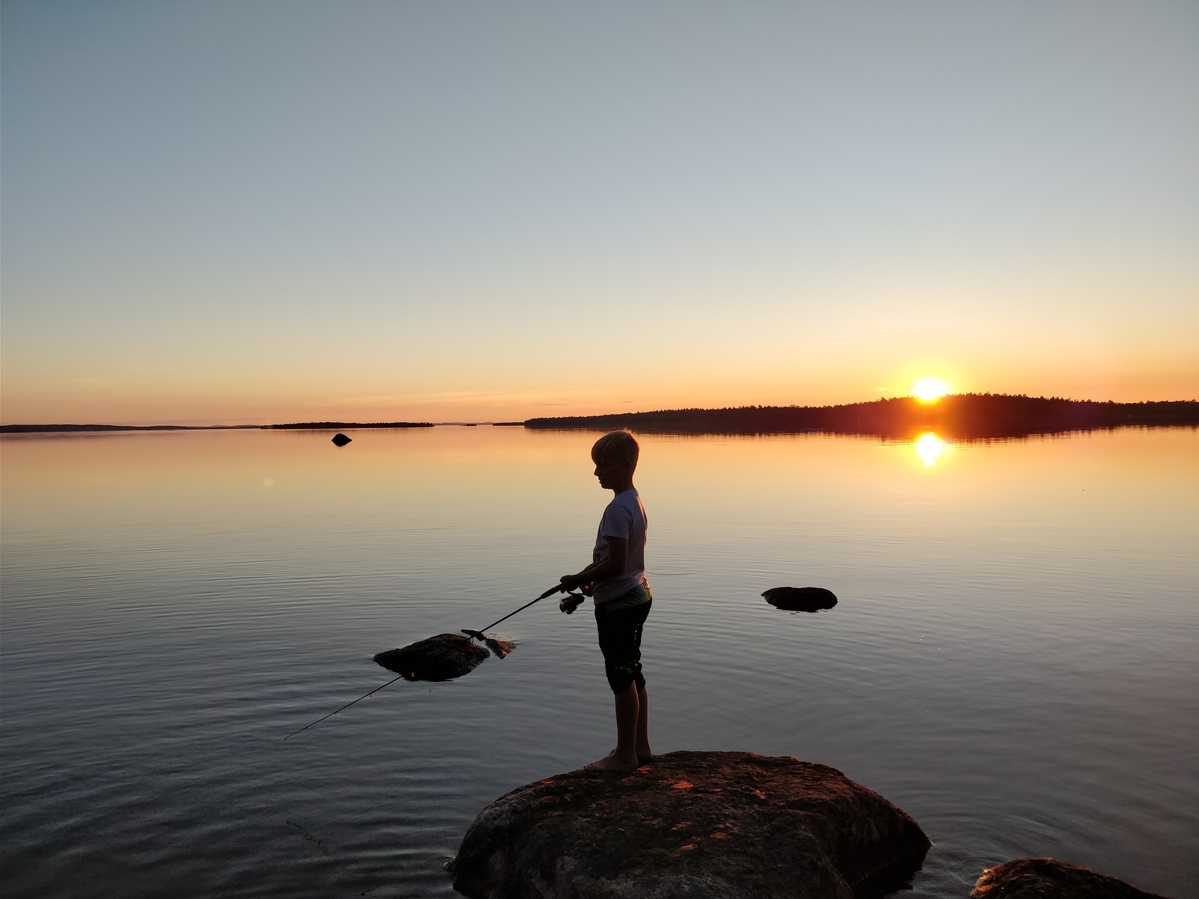Inarijärven yötön yö lumoaa nuoren kalamiehen.