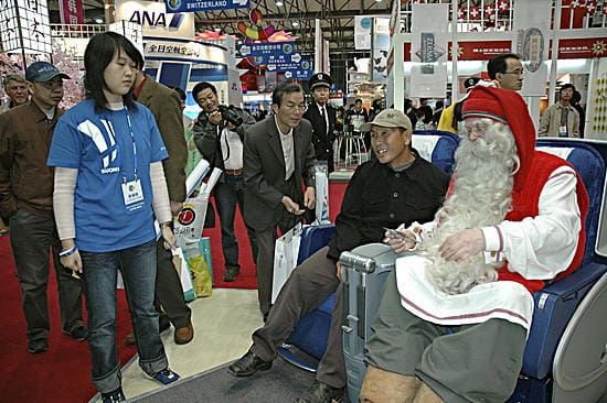 Kiinalaiset jonottavat innolla yhteiskuvaan joulupukin kanssa.