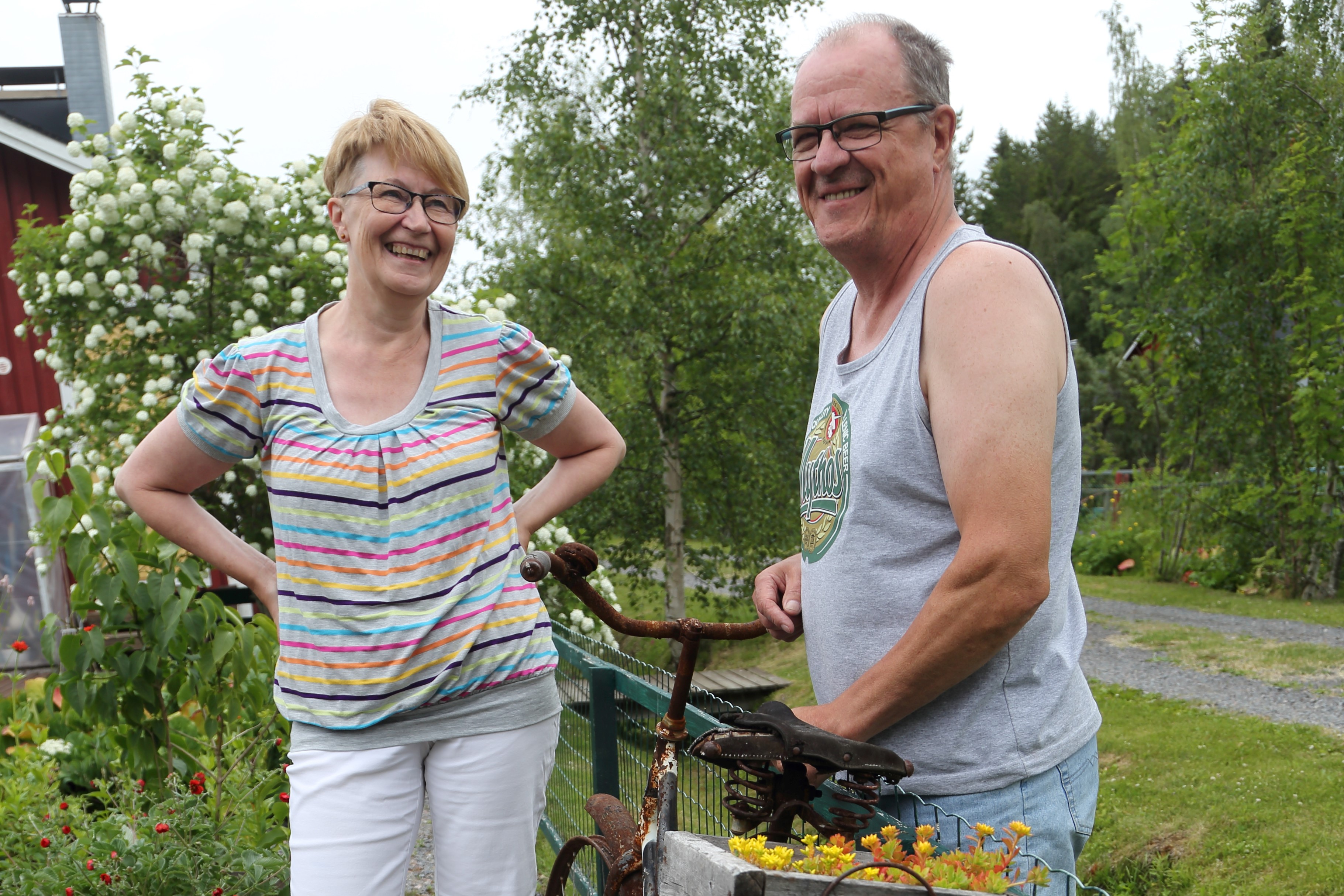 Aija ja Kalle Tarujärvi suosivat palstallaan kierrätysmateriaaleja. Vanha pyörä toimittaa kukkatelineen virkaa.