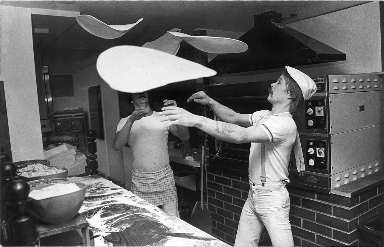Kuvassa Seppo Ruonala heittää pizzapohjia ilmaan 70-luvun lopulla. Edelleenkin hän viimeistelee pizzapohjat heitolla, jolloin pohjan saa riittävän ohueksi.
