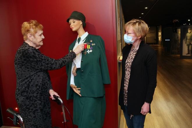 Raili Mäkelä esitteli museointendentti Hanna Rieckille pukuun kiinnitettyjä ansio- ja kunniamerkkejä. Oikealla on kaatuneen äidille tai leskelle myönnetty sururisti, jota vielä saajan vanhimmalla tyttärellä on oikeus käyttää. KUVA: ANU NAHKALA