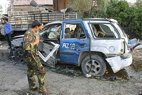 LKS 20060828 CBS005; An Iraqi Army soldier approaches one of the vehicles destroyed after two near simultaneous suicide car bomb attacks on Kurdish targets killed 10 and wounded 50 more in the ethnically mixed northern Iraqi city of Kirkuk, late 27 August