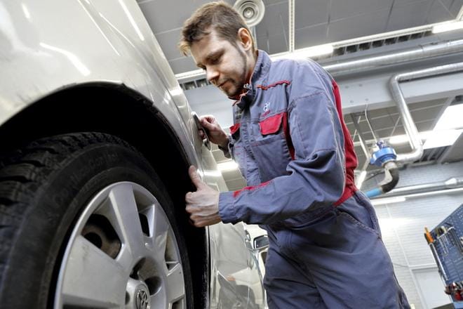 Korimekaanikko Toni Ylä-Pöntinen päivän urakan kimpussa Maakunnan Autossa. Ajopelin takakaari ja oven takaosa ovat saaneet tällin eli tämä on oikomishoidon paikka. Vaimo ja kolme alle kouluikäistä lasta odottavat isäänsä iltavuoroon kotona Jalasjärvellä. KUVA: HEIKKI HAKANEN