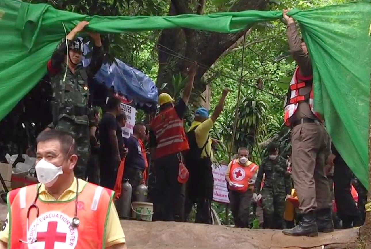 epa06874594 A handout photo made available by the Chiang Rai Public Relations Office on 09 July 2018 shows emergency workers carrying one of the boys from a youth soccer team to transport him to a hospital at Tham Luang cave in Khun Nam Nang Non Forest Park, Chiang Rai province, Thailand, 08 July 2018. According to reports, four boys have been rescued and evacuated to a hospital on 08 July 2018, as rescue operations continue for the 13 members of a youth soccer team including their assistant coach who have been trapped in Tham Luang cave since 23 June 2018. Operations are underway to safely bring out the rest of them after the oxygen tanks are refilled. EPA/CHIANG RAI PR OFFICE HANDOUT BEST QUALITY AVAILABLE HANDOUT EDITORIAL USE ONLY/NO SALES BY: ALL OVER PRESS / EPA-PHOTO CODE: EPAXX8